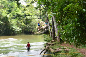 Belize cave tubing river rock jump